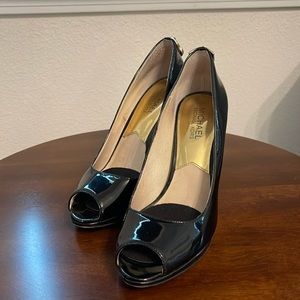 Gently used Michael Kos pattern leather peek a boo bumps